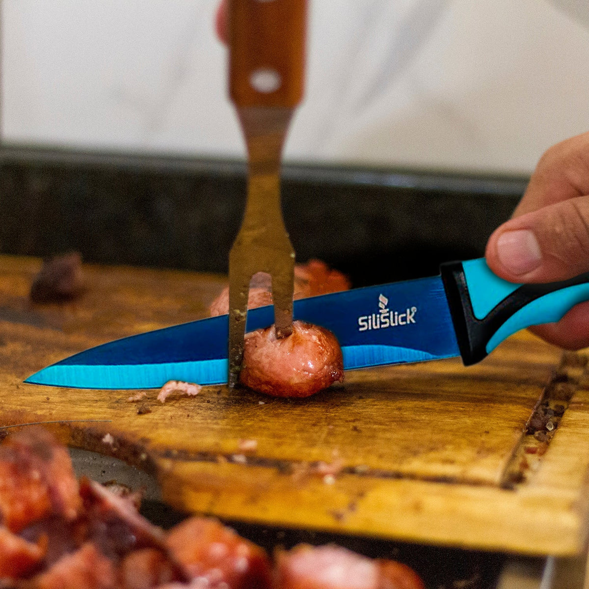 https://www.silislick.com/cdn/shop/products/Bluebladechefknifecuttingpotatoes_1200x1200.jpg?v=1667411066